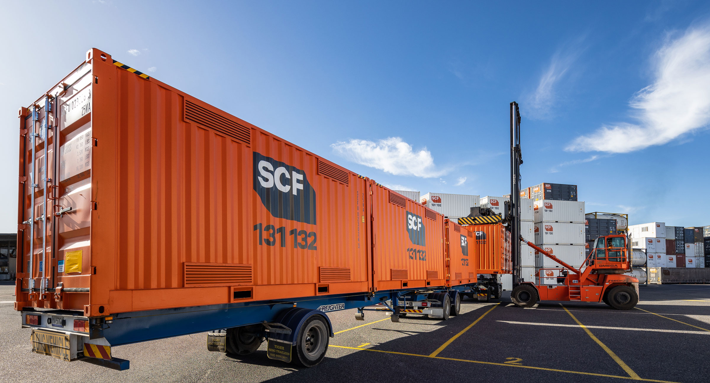 Multiple 20ft SCF Dangerous Goods Containers being loaded in depot