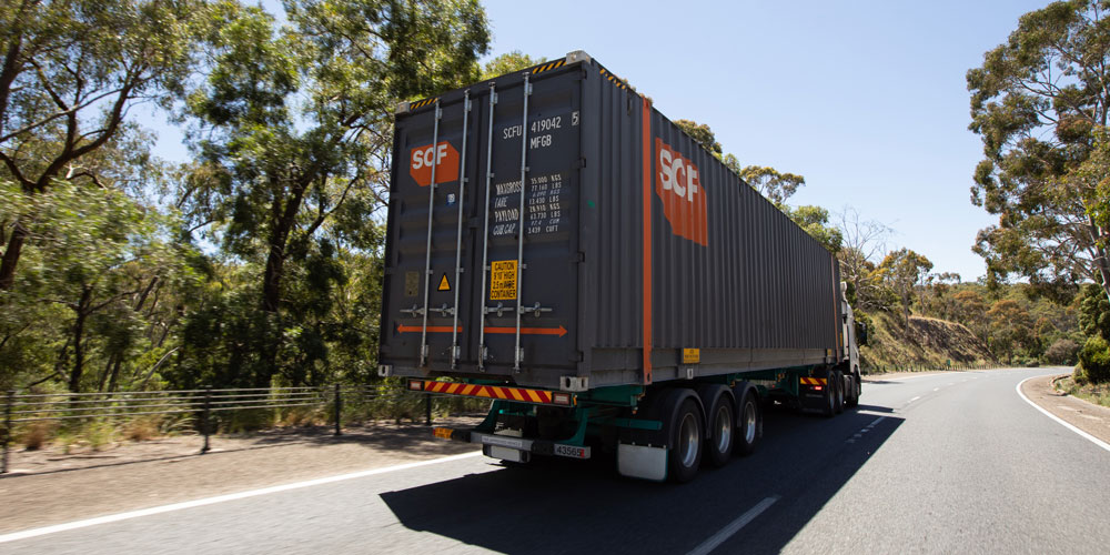 SCF Pallet Wide container being transported by a truck on road
