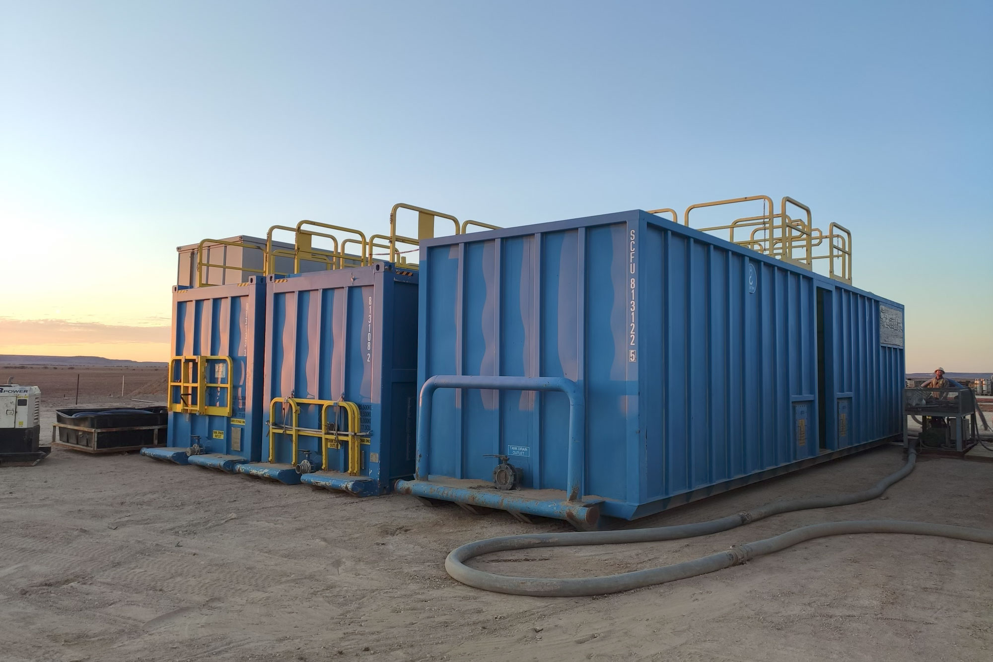 SCF BLS Tanks on a drill site at sunrise