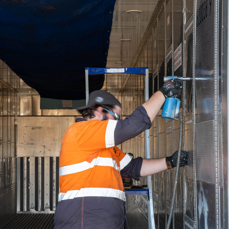 SCF worker repairing the internals of a refrigerated container