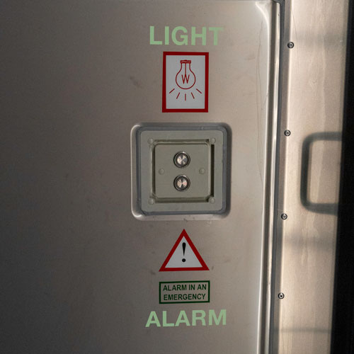 A light switch and alarm on a SCF Reefer container. The alarm works even when the unit is not plugged in to protect operators.